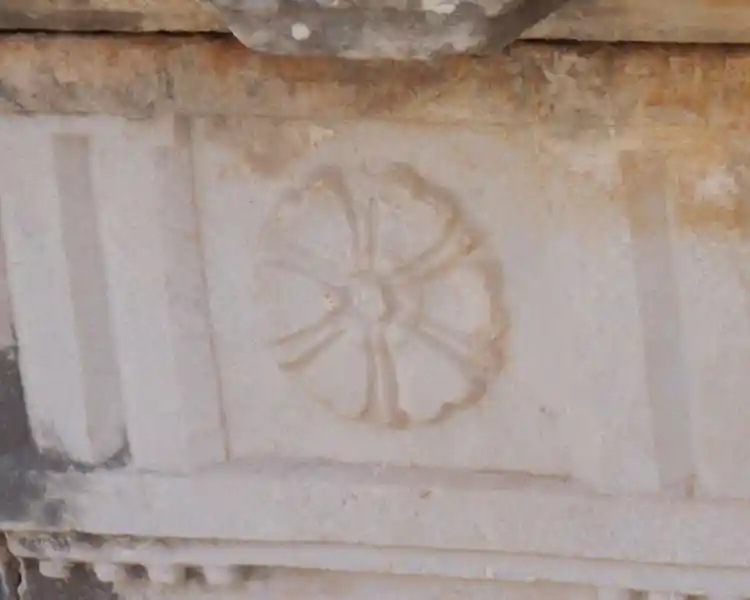 Flower-like solar disc on a marble stone